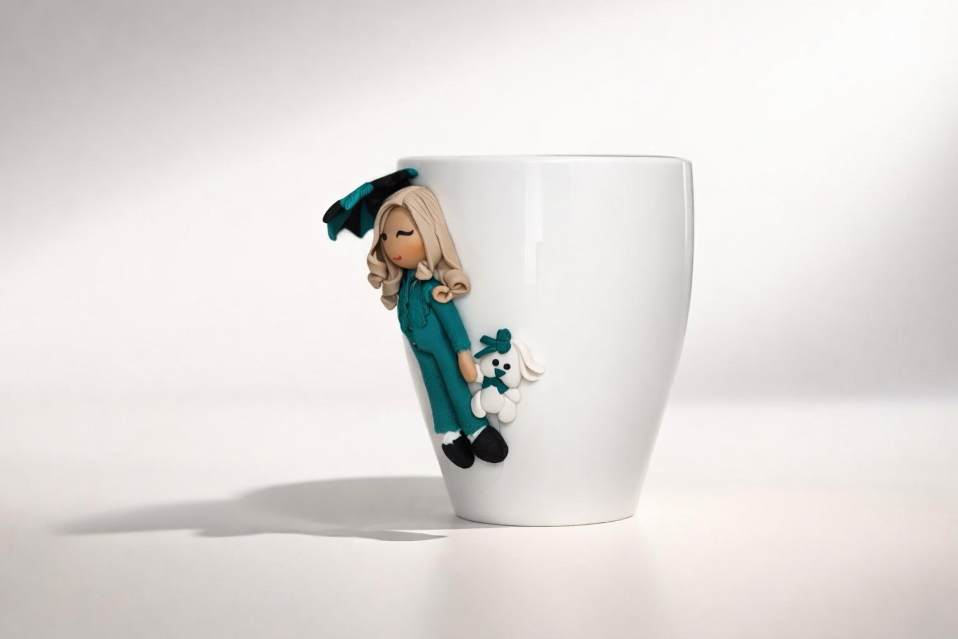 Ceramic mug with hand-modeled 3D doll figurine with umbrella and bunny made of polymer clay