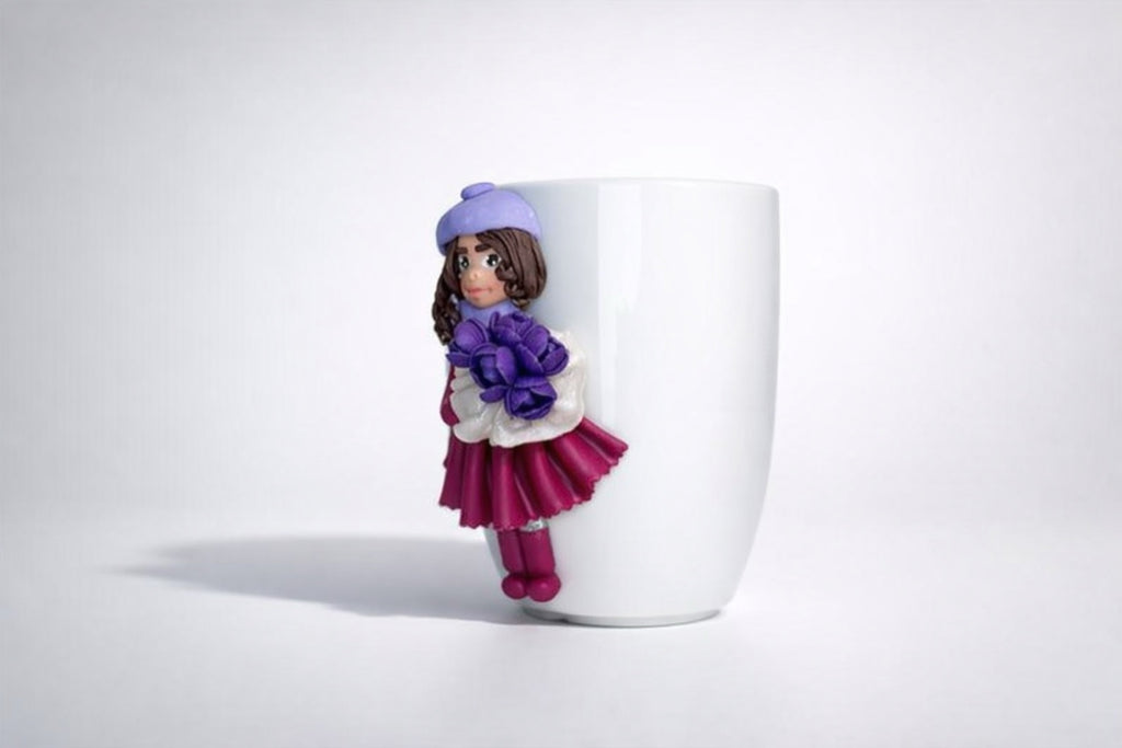 Feldspar porcelain cup with hand-modeled 3D doll figurine holding a bouquet of tulips made of polymer clay 