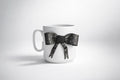 Porcelain cup with hand-modeled 3D bow made of polymer clay 