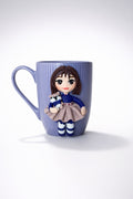 Ceramic mug with hand-modeled 3D doll figure and raccoon made of polymer clay 