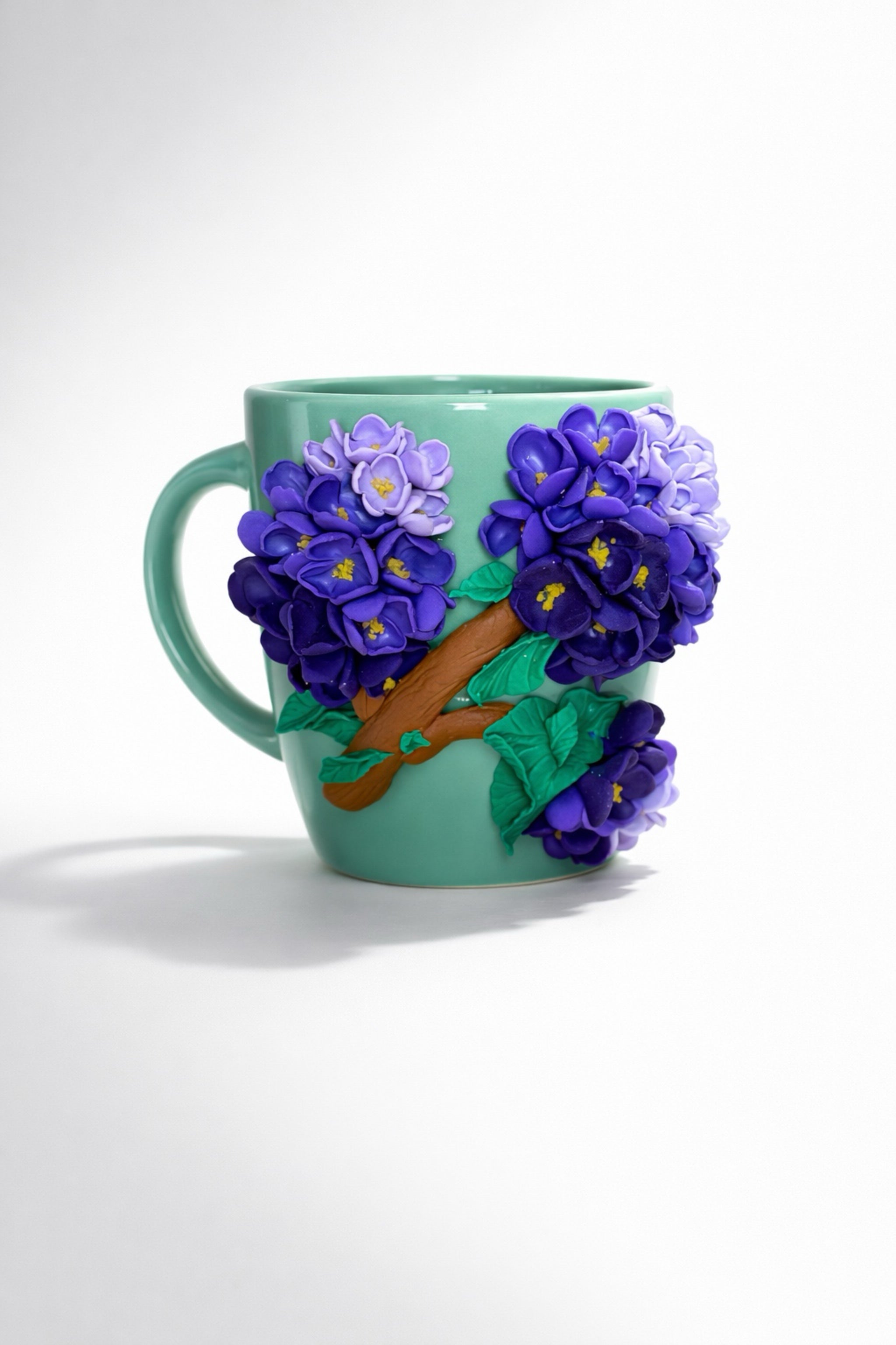 Ceramic mug with hand-modeled 3D lilac blossoms made of polymer clay 