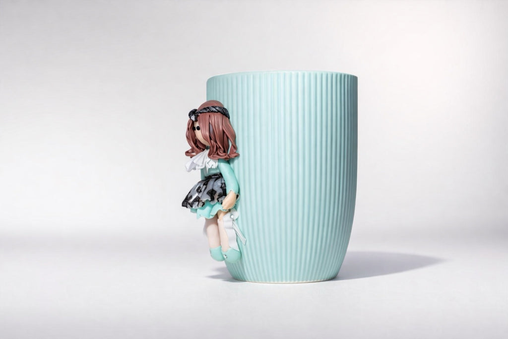 Ceramic mug with hand-modeled 3D doll figure made of polymer clay