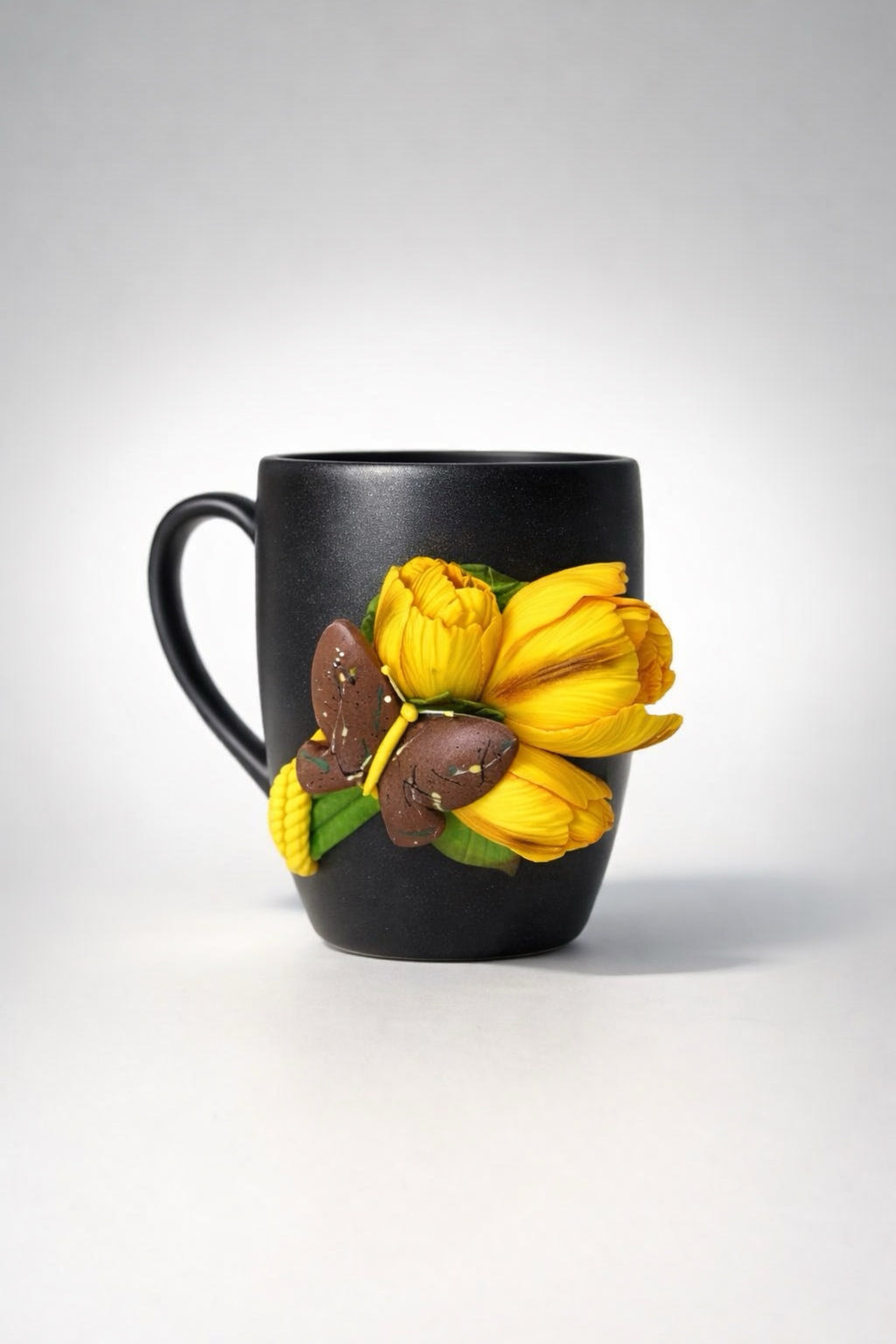 Stoneware mug with hand-modeled 3D tulips and butterfly made of polymer clay 