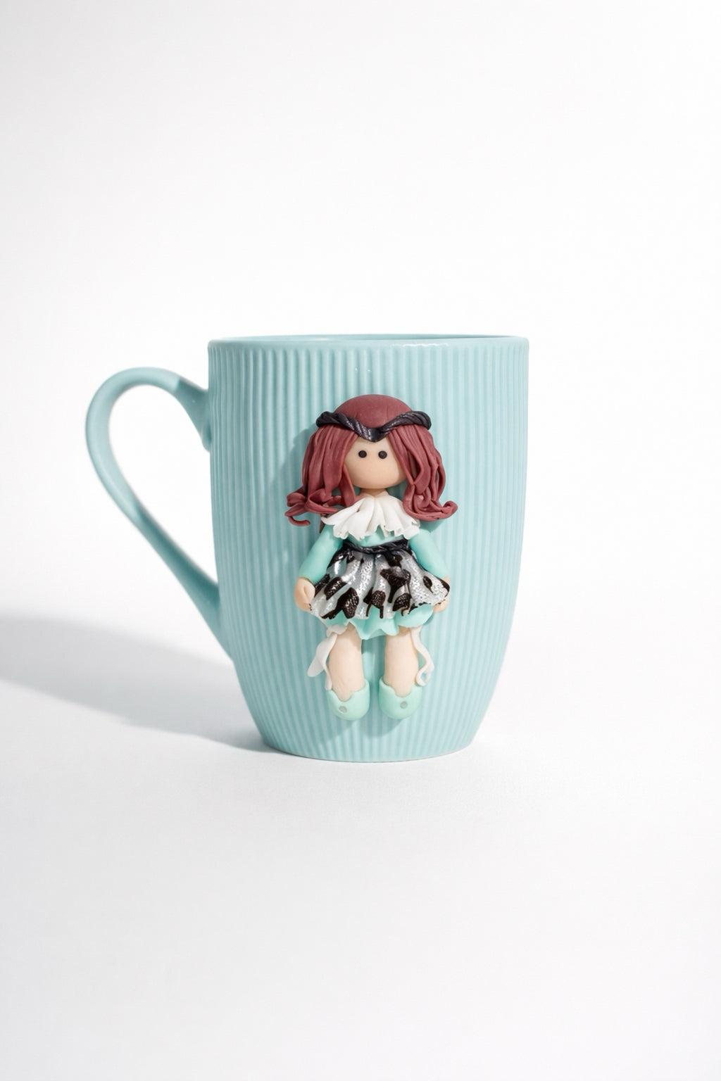 Ceramic mug with hand-modeled 3D doll figure made of polymer clay
