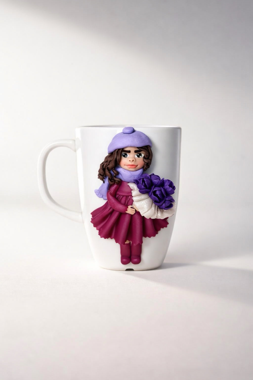 Feldspar porcelain cup with hand-modeled 3D doll figurine holding a bouquet of tulips made of polymer clay 