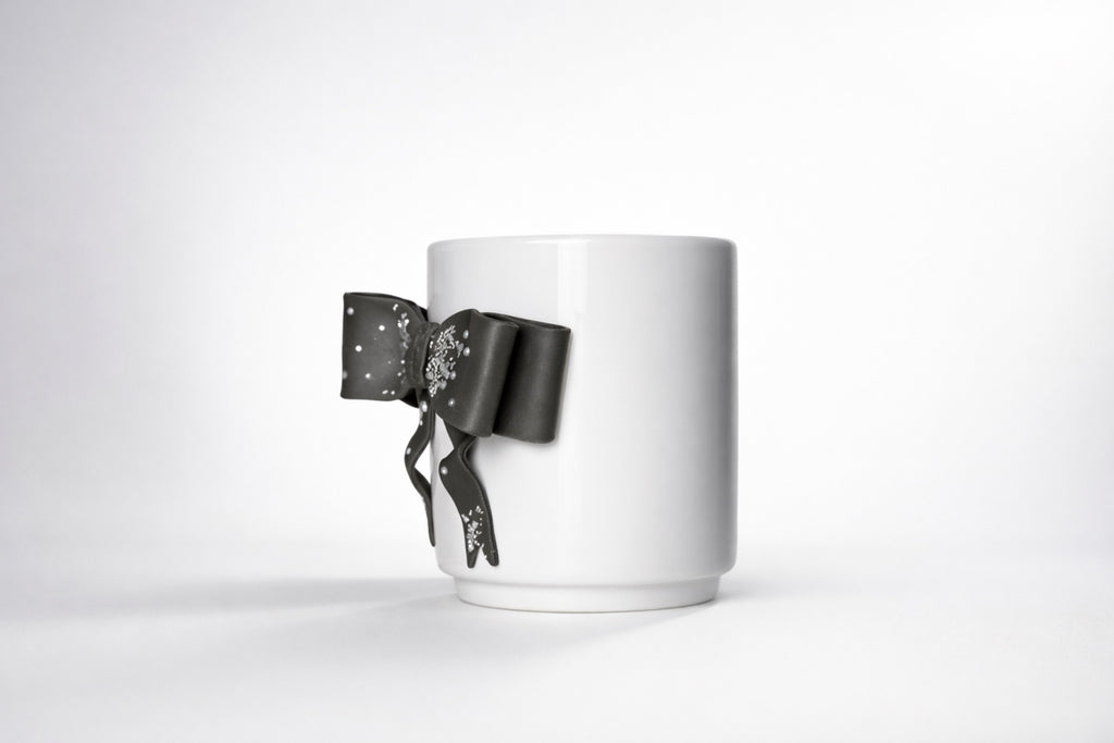 Porcelain cup with hand-modeled 3D bow made of polymer clay 